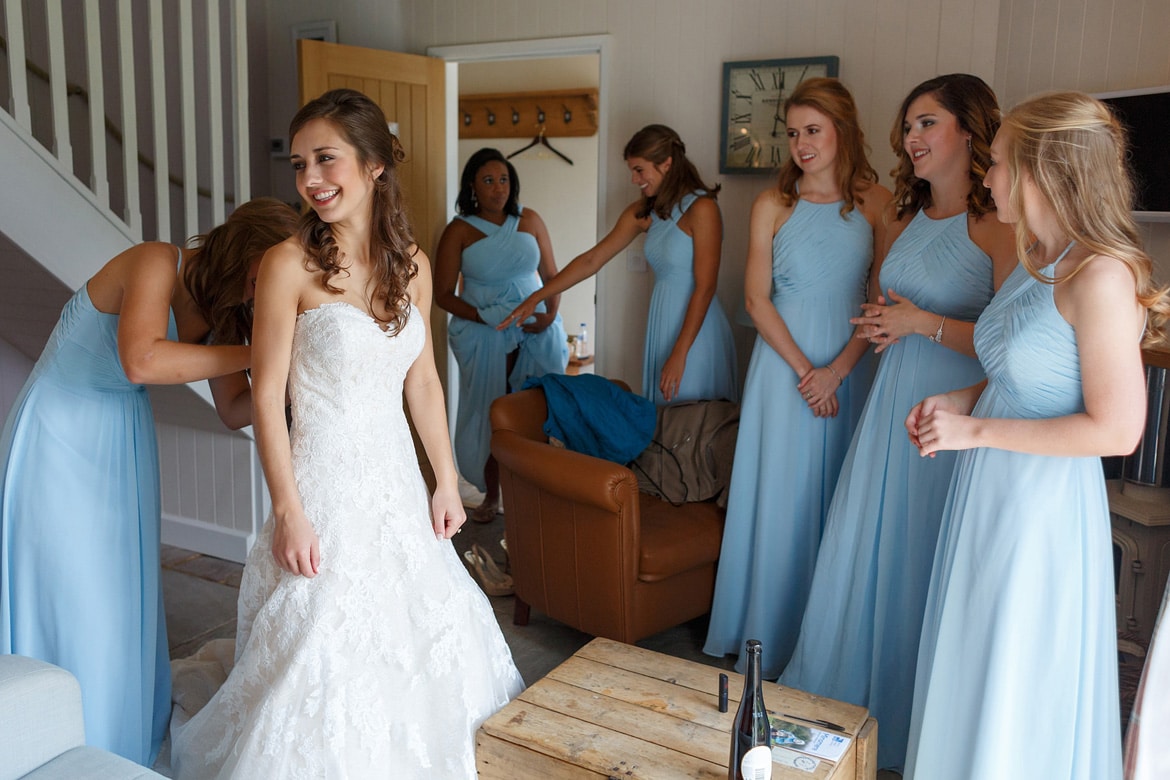 the bride laughs with her bridesmaids