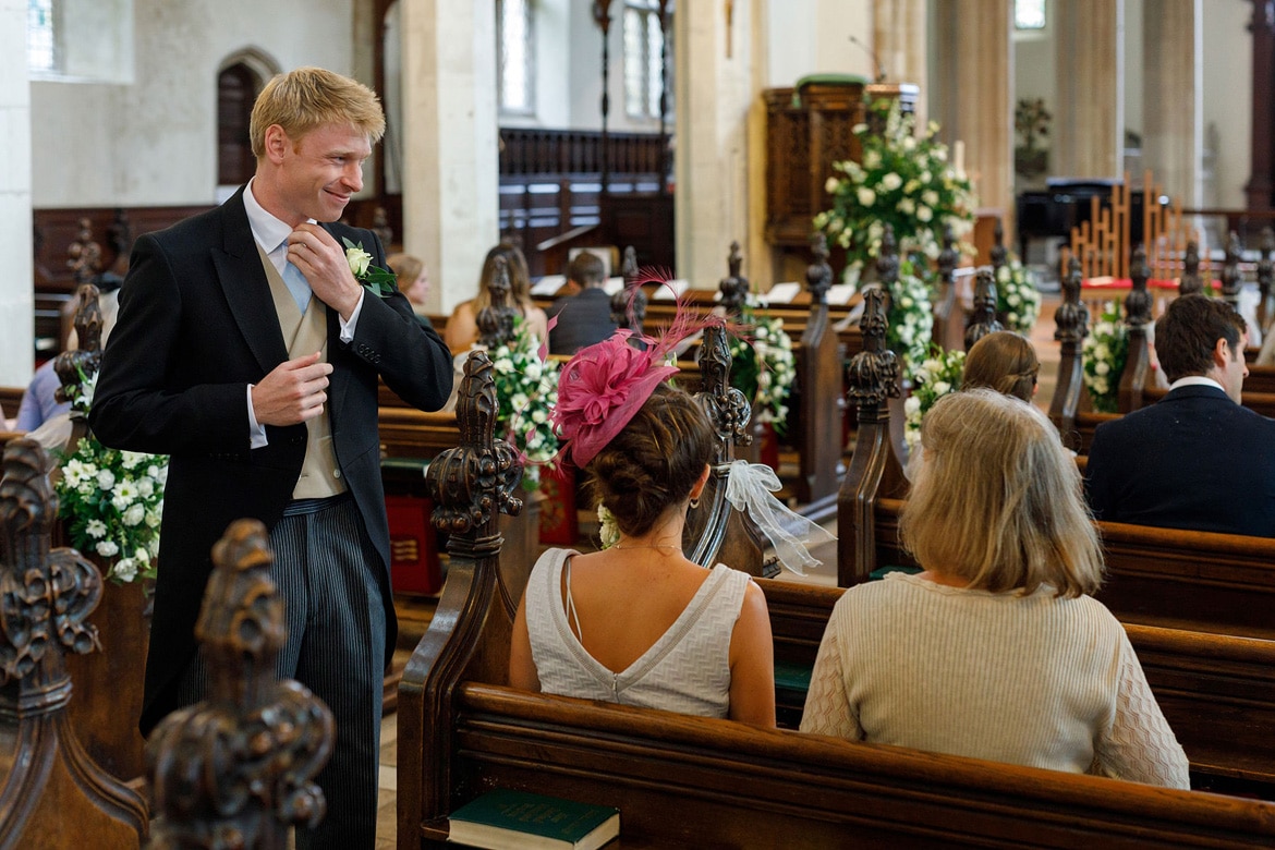 the groom greets guests in framlingham church