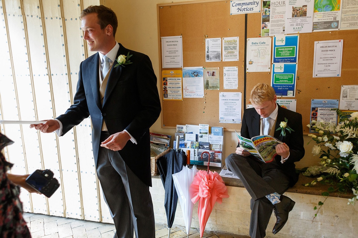 the groom reads a farming magazine in framlingham church