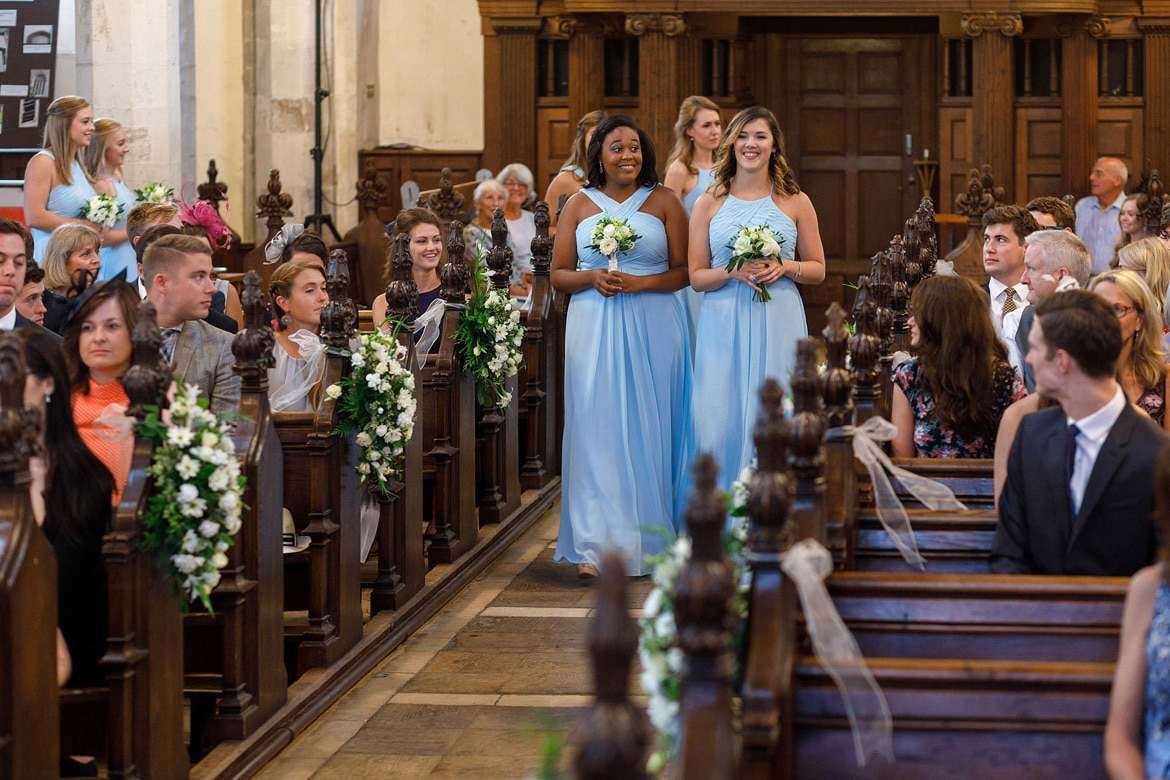 the bridesmaids walk down the aisle