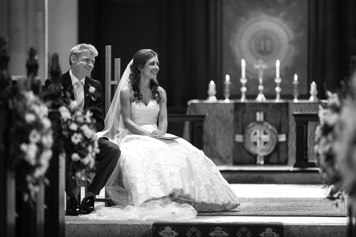 while the bride and groom look on