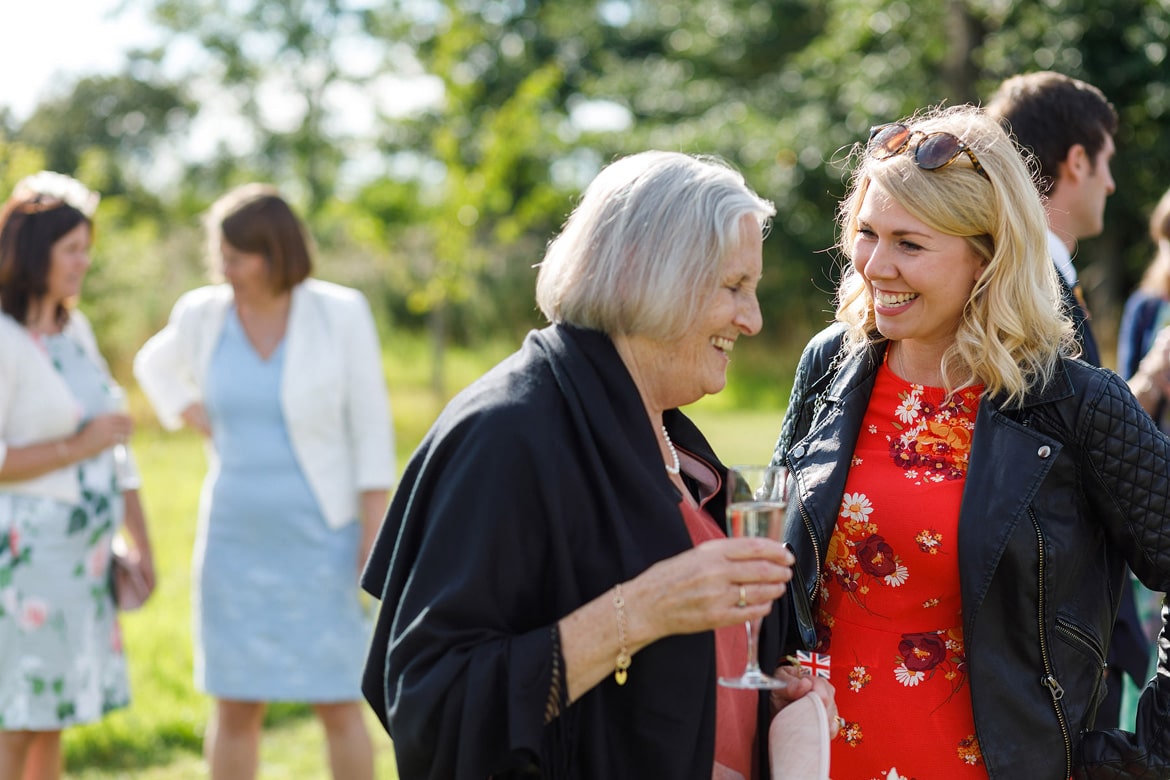 two guests drinking and laughing