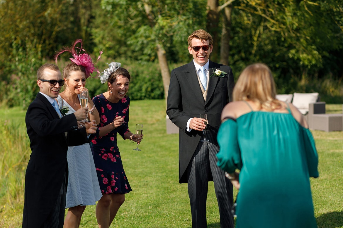 some wedding guests laugh at a another guest