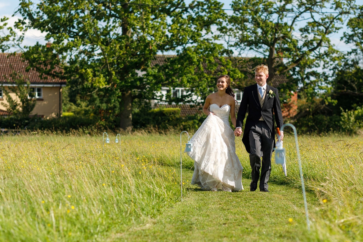 the bride and groom arrive at their reception