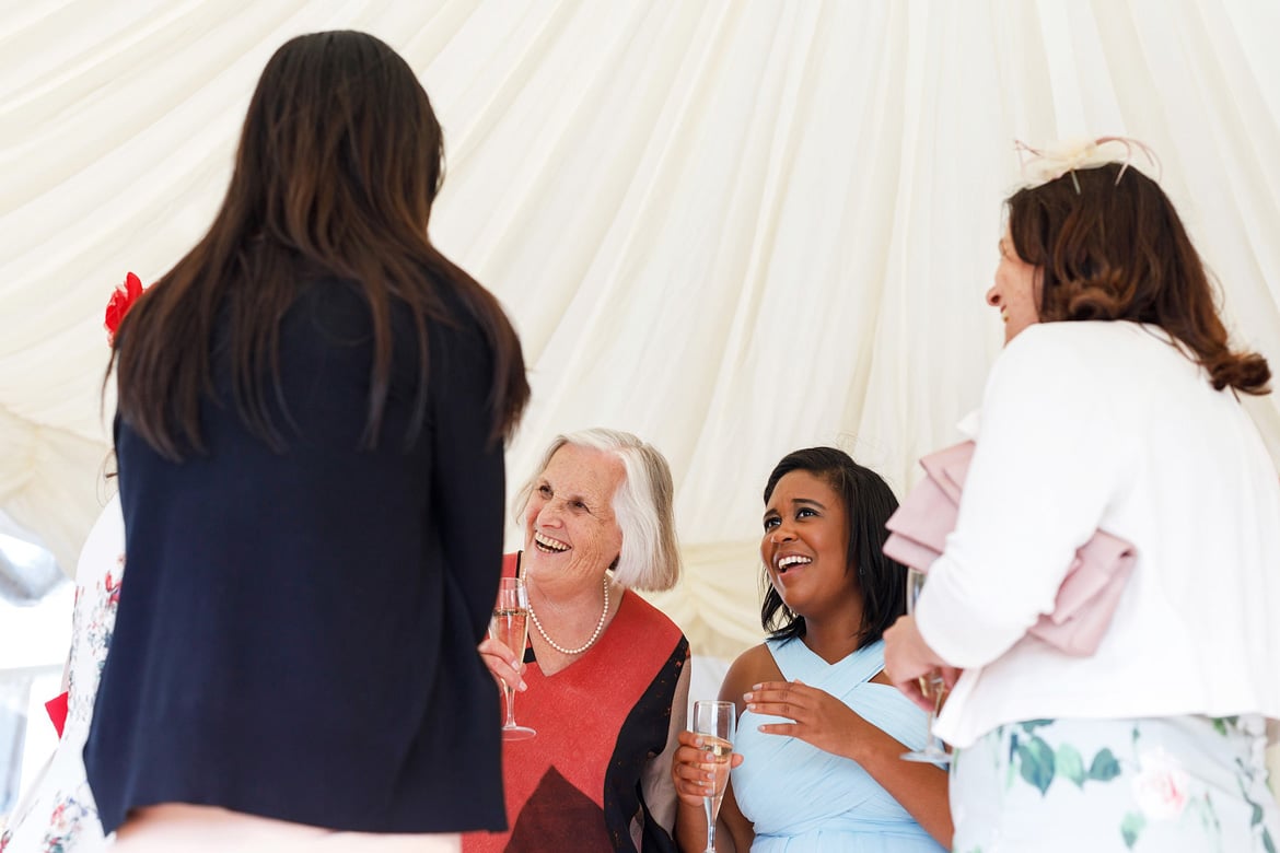 a bridesmaid talks to a grandmother