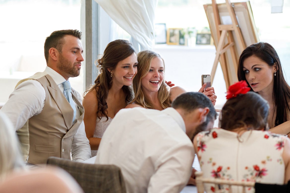 the bride takes a selfie with the guests