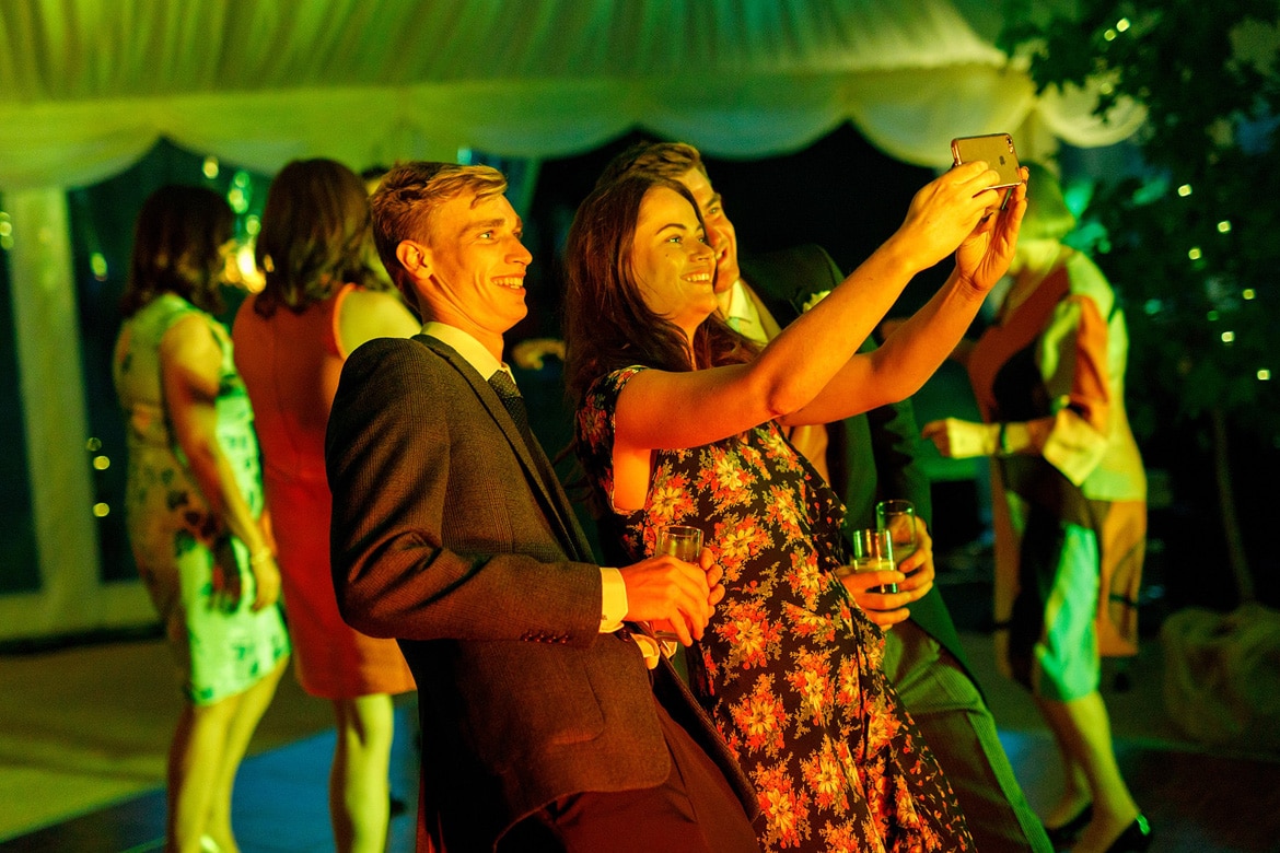 guests take selfies on the dancefloor