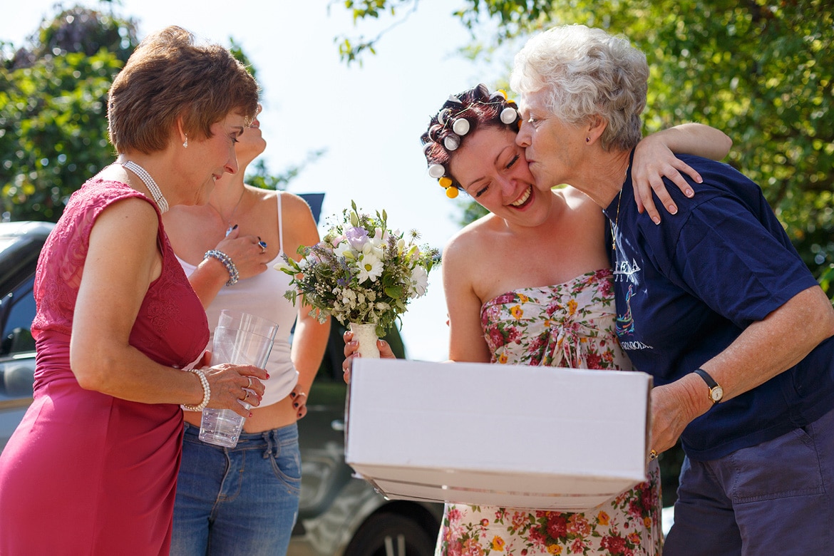 the bride gets a kiss from the florist