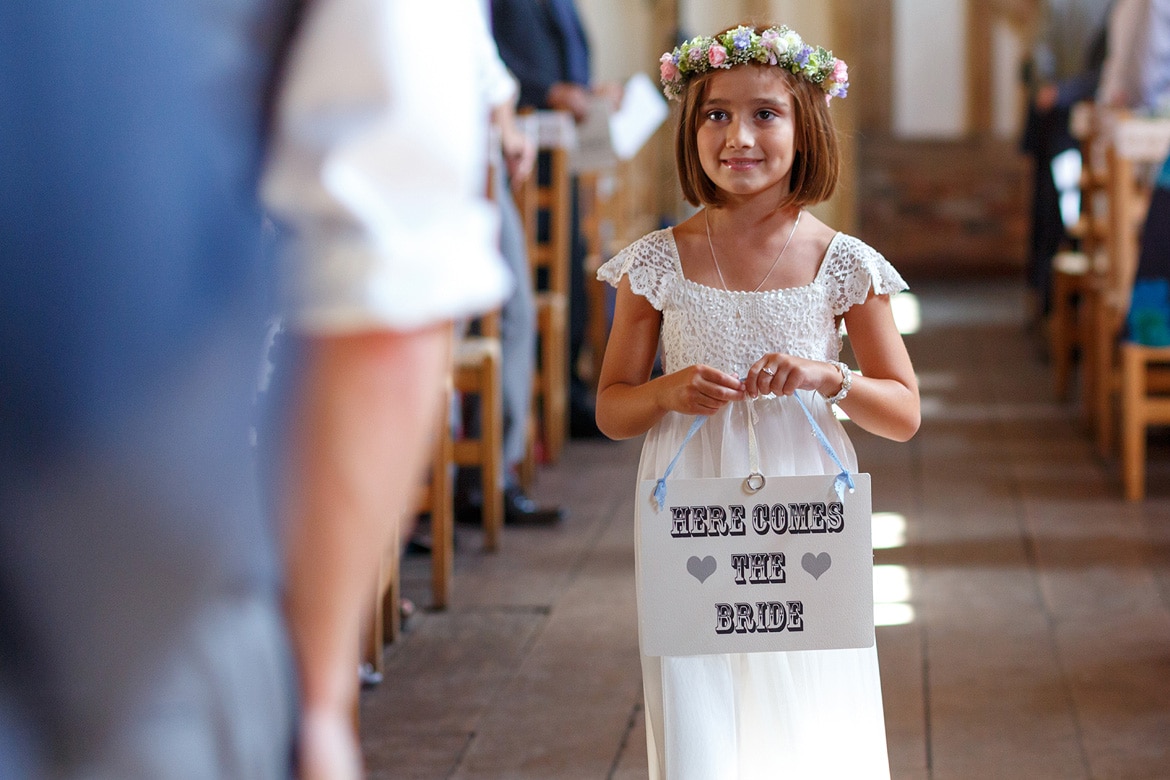 the flowergirl walks down the aisle