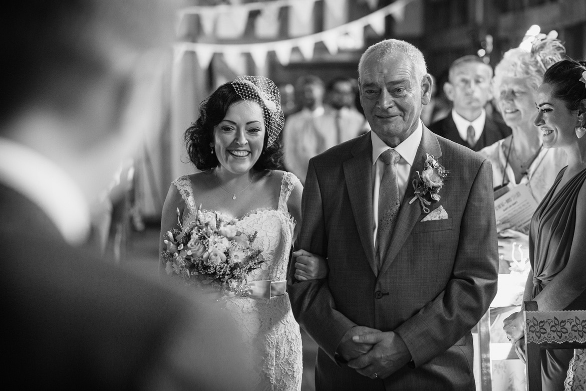 sian and her dad walk down the aisle at gate street barn