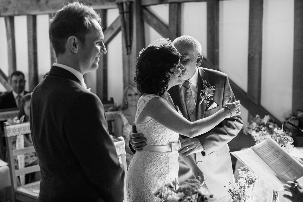 the bride kisses her father at the start of the ceremony