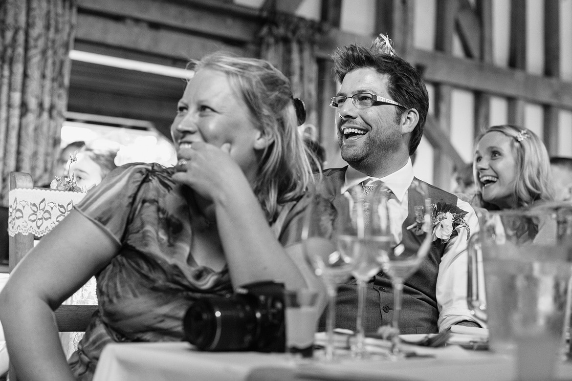 guests laugh at the groom