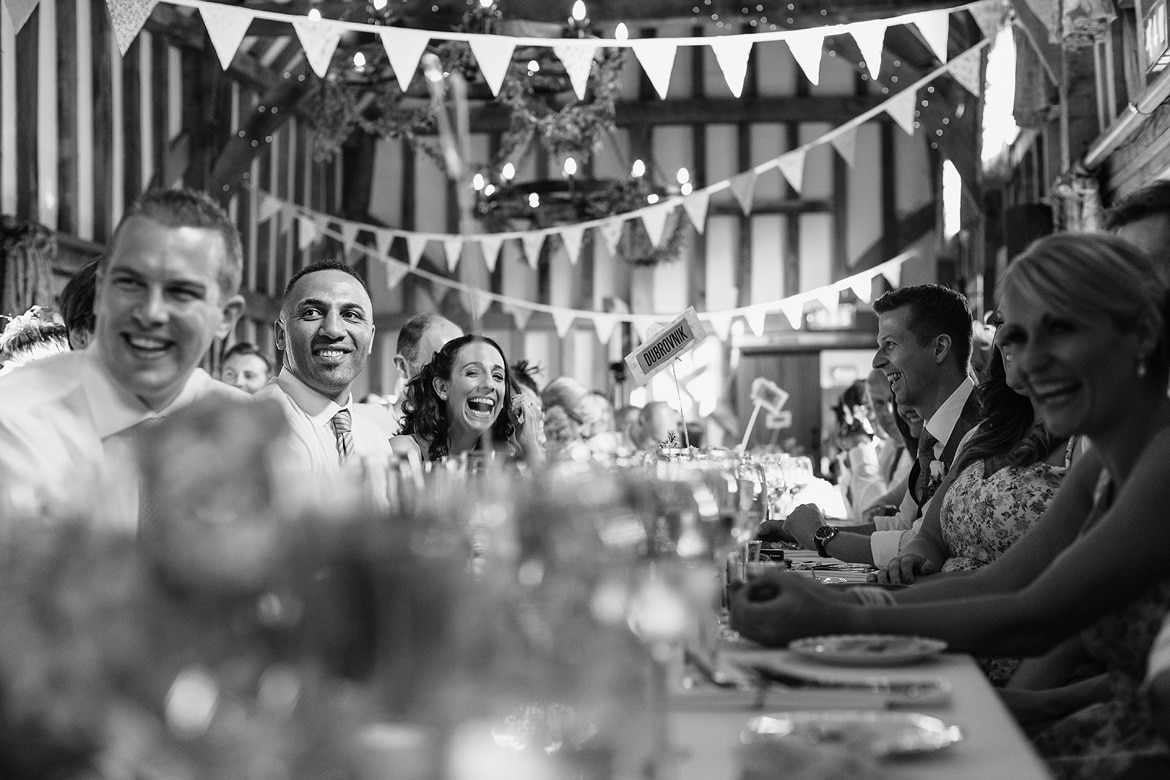 guests laugh at the grooms speech