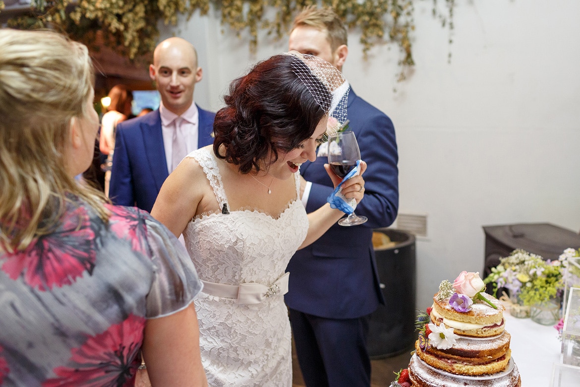 the bride looking at her wedding cake