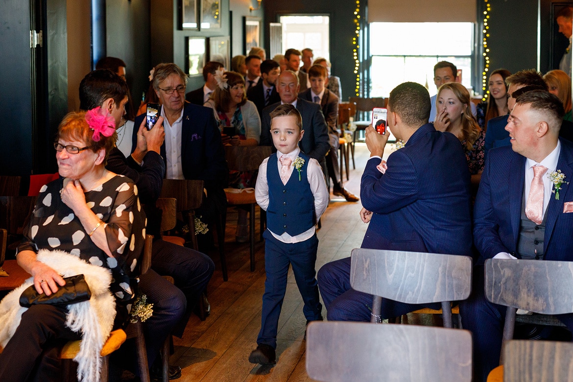 a page boy walks down the aisle