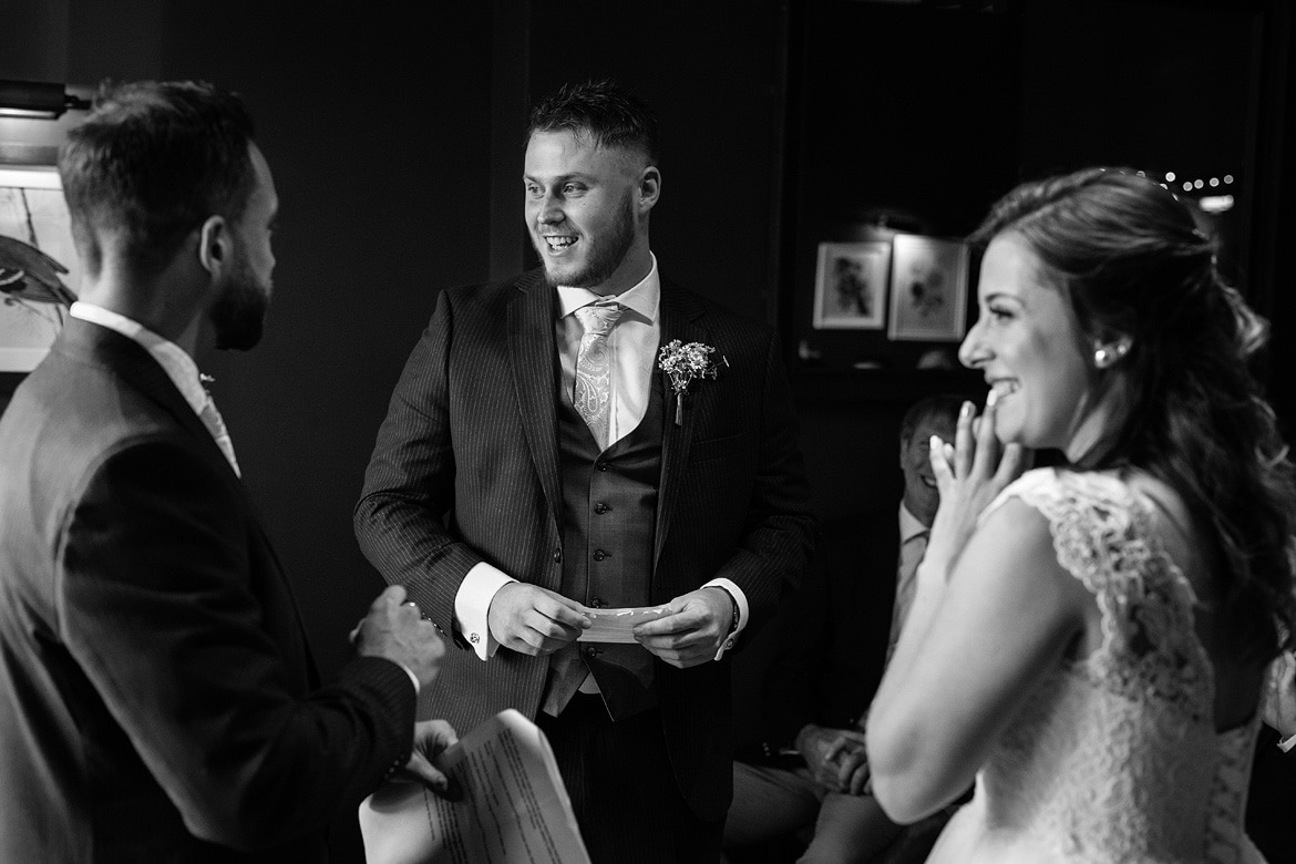 bride and groom smile with the celebrant