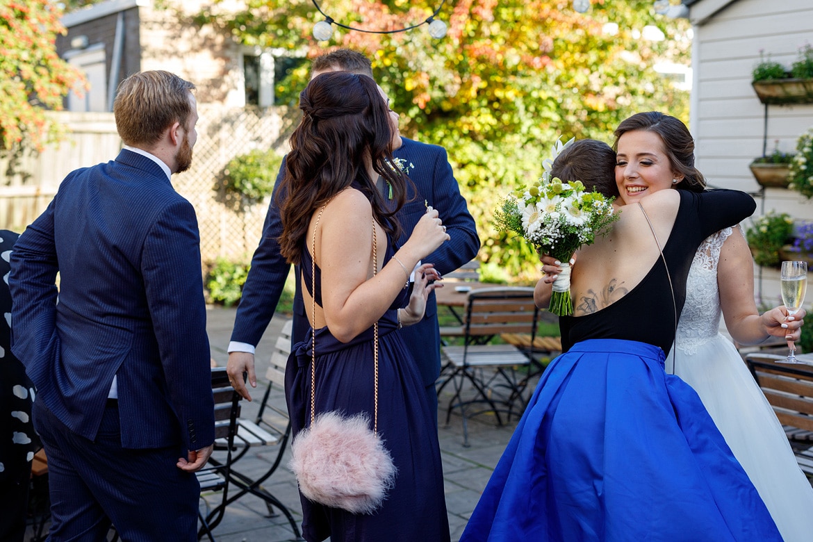 the bride hugs her friends in the garden