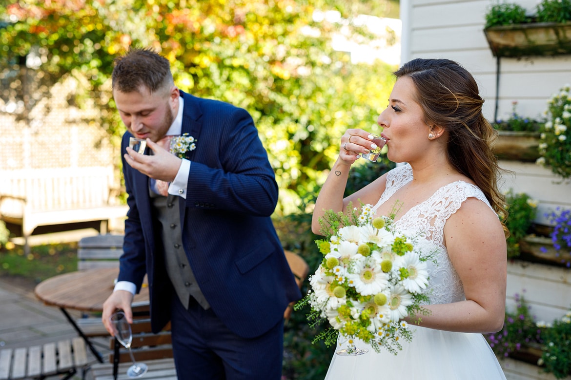 bride and groom drink shots of tequila