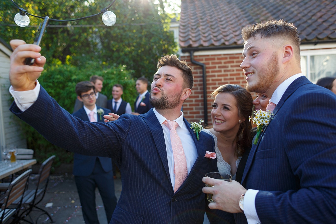 a quick selfie with the bride and groom