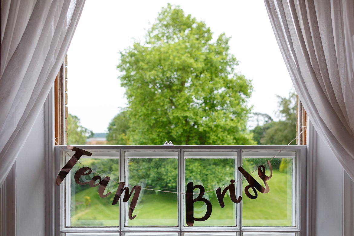 team bride sign hanging in a window at Godwick hall