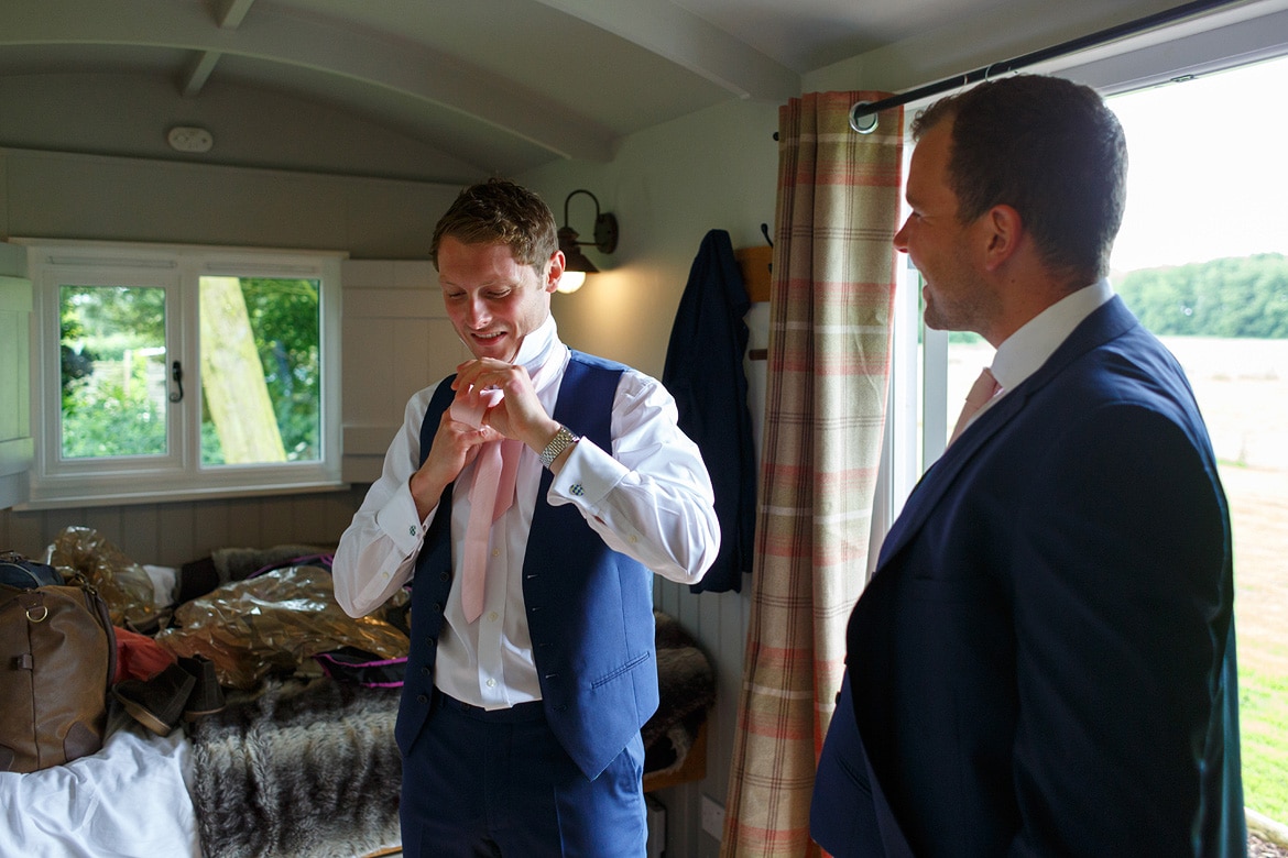 george putting on his wedding tie