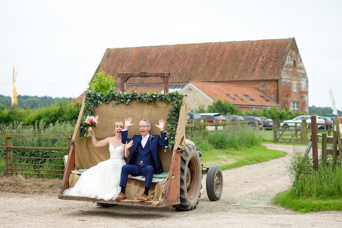 laura and her dad in the tractor before a godwick barn wedding