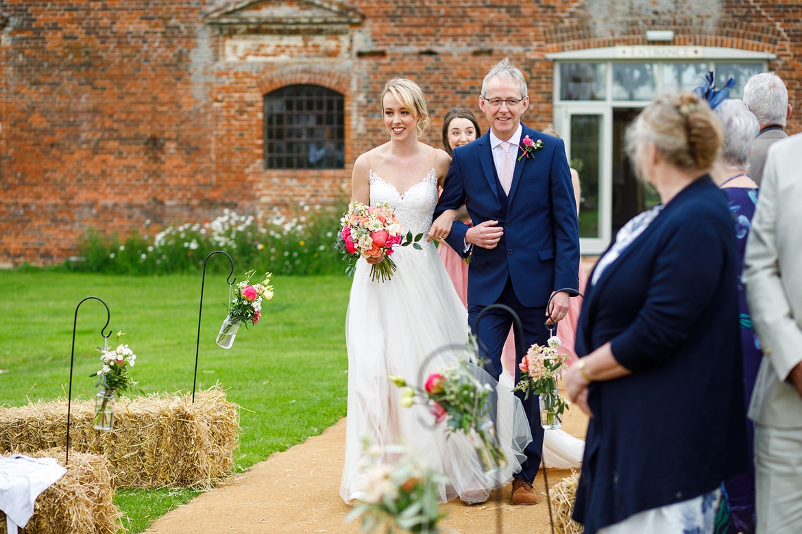 laura arrives at her godwick barn wedding ceremony