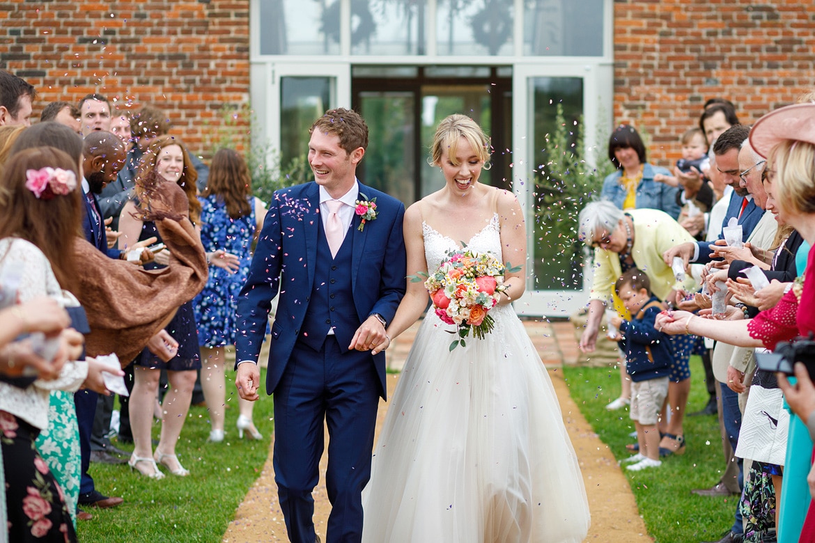 walking through the confetti outside godwick barn