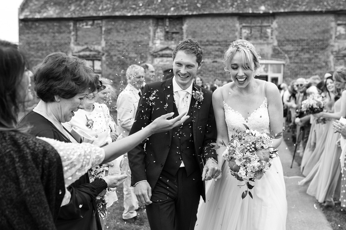 walking through the confetti outside godwick barn