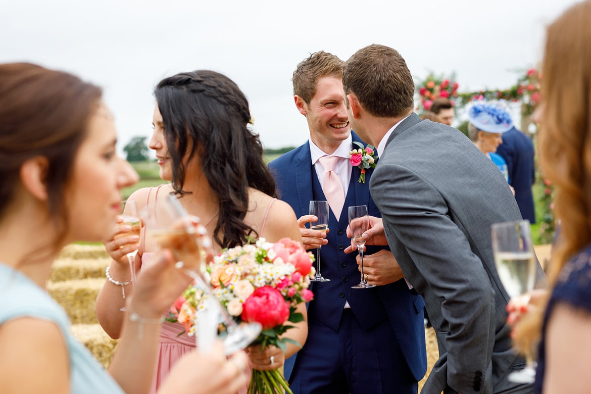 the groom and a guest share a joke