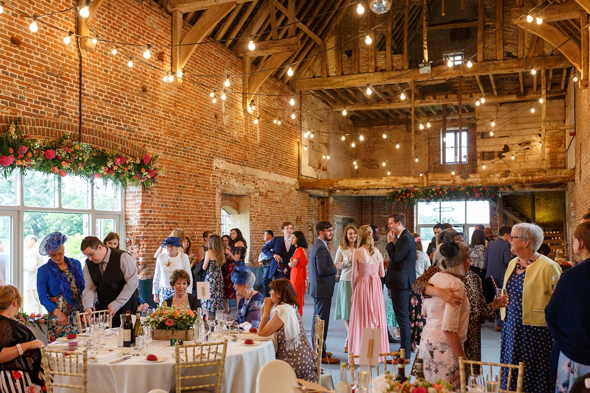 guests waiting for the wedding breakfast inside godwick barn