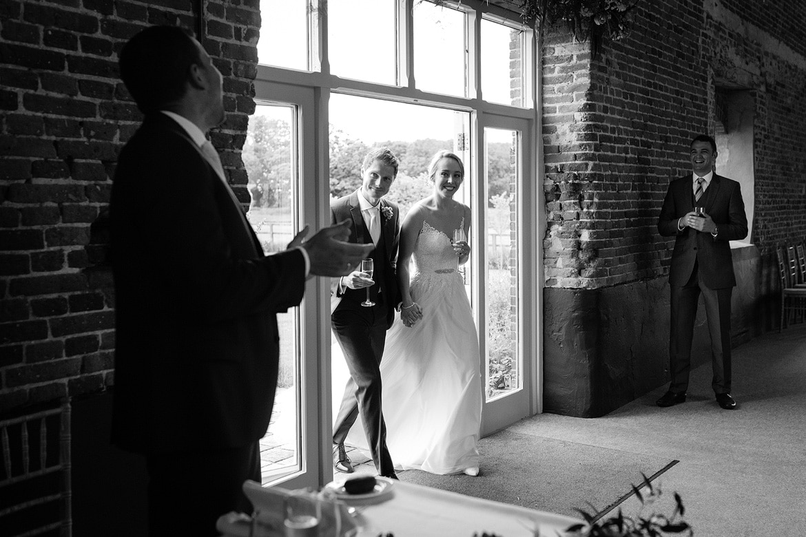 bride and groom enter godwick barn