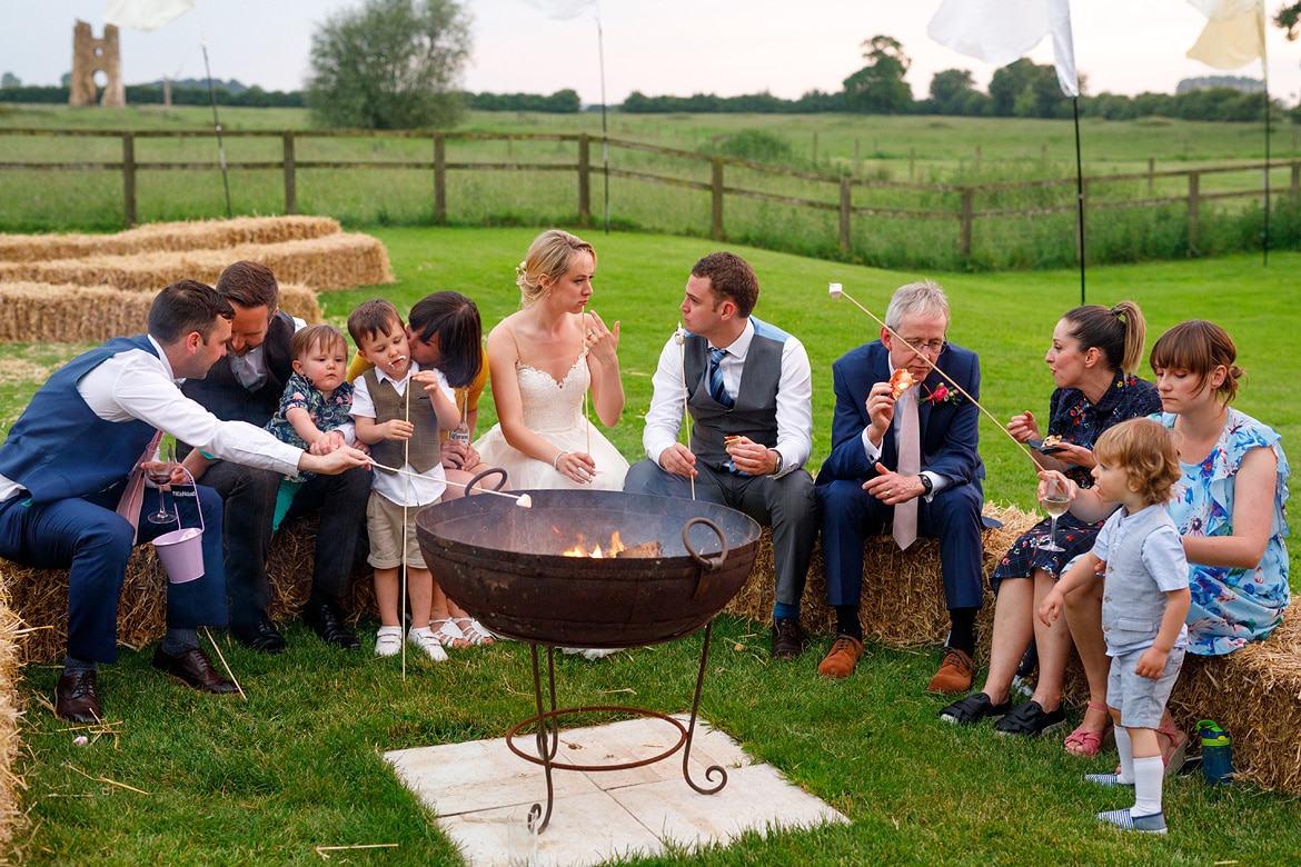 wedding guests enjoy the fire pits at godwick