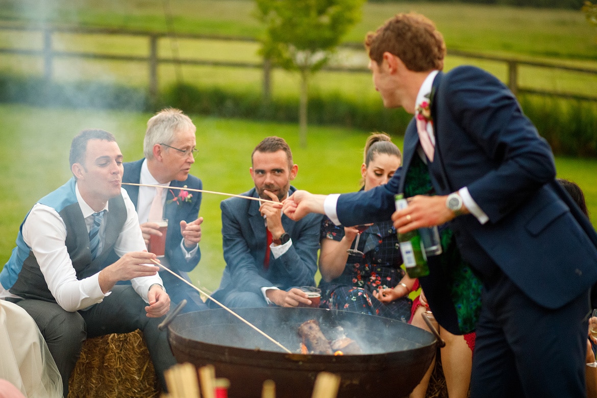 the groom feeds a guest marshmallows