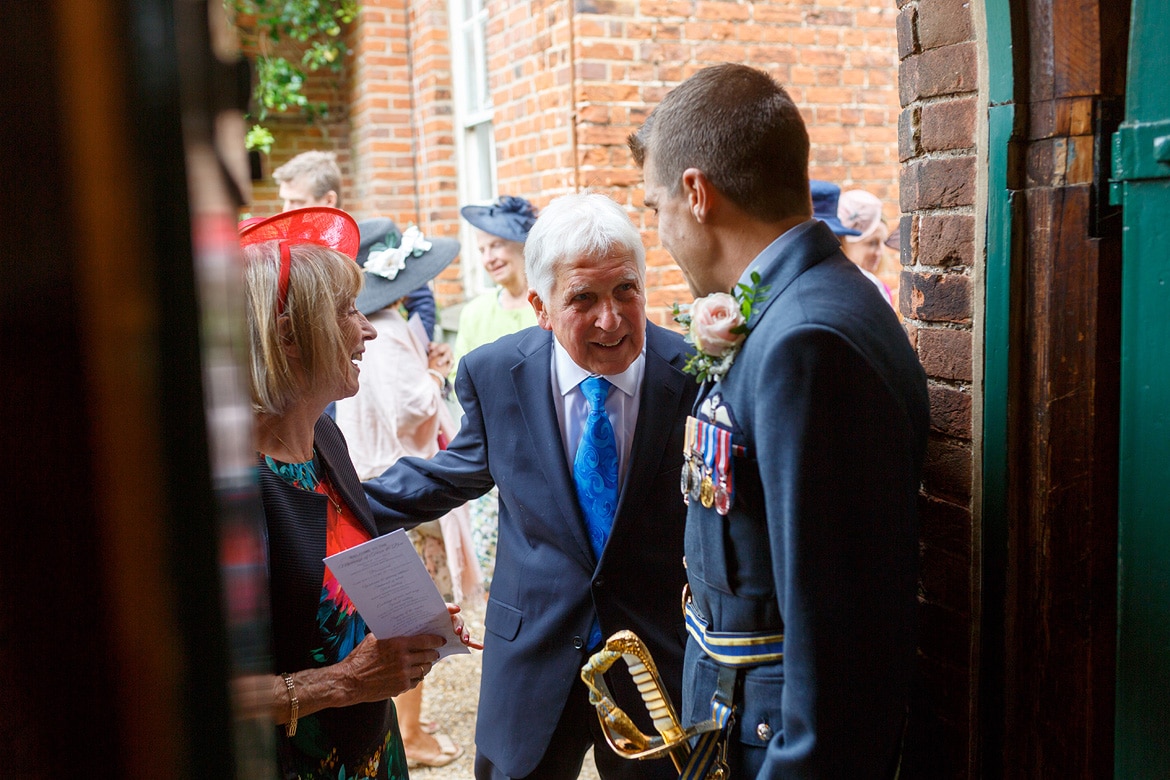the groom greets guests at the gressenhall chapel