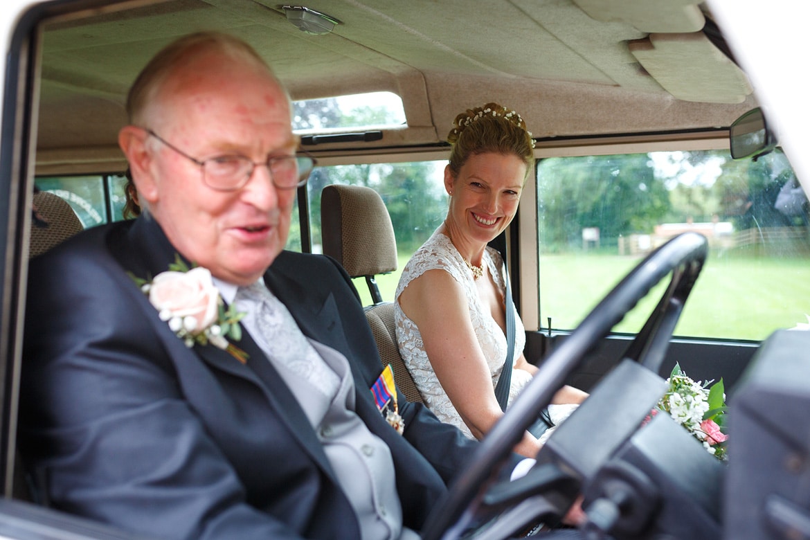 the bride and her father in the wedding car