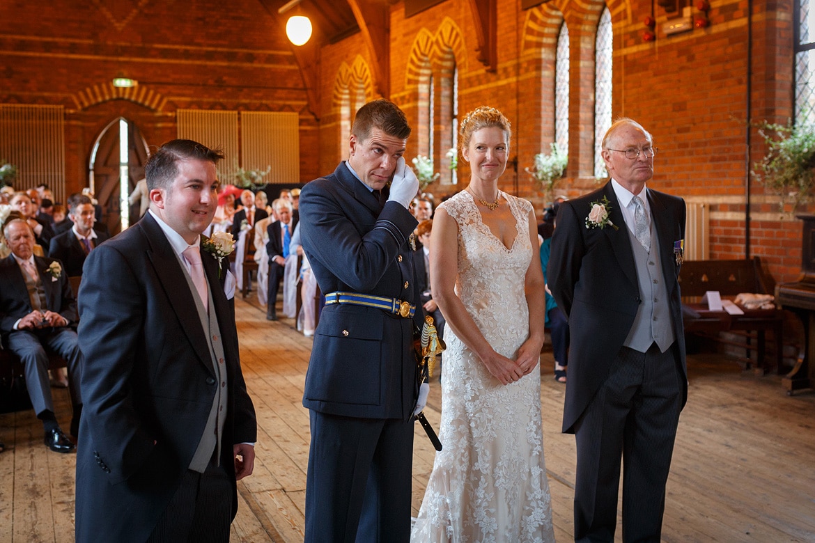 the groom wipes away a tear