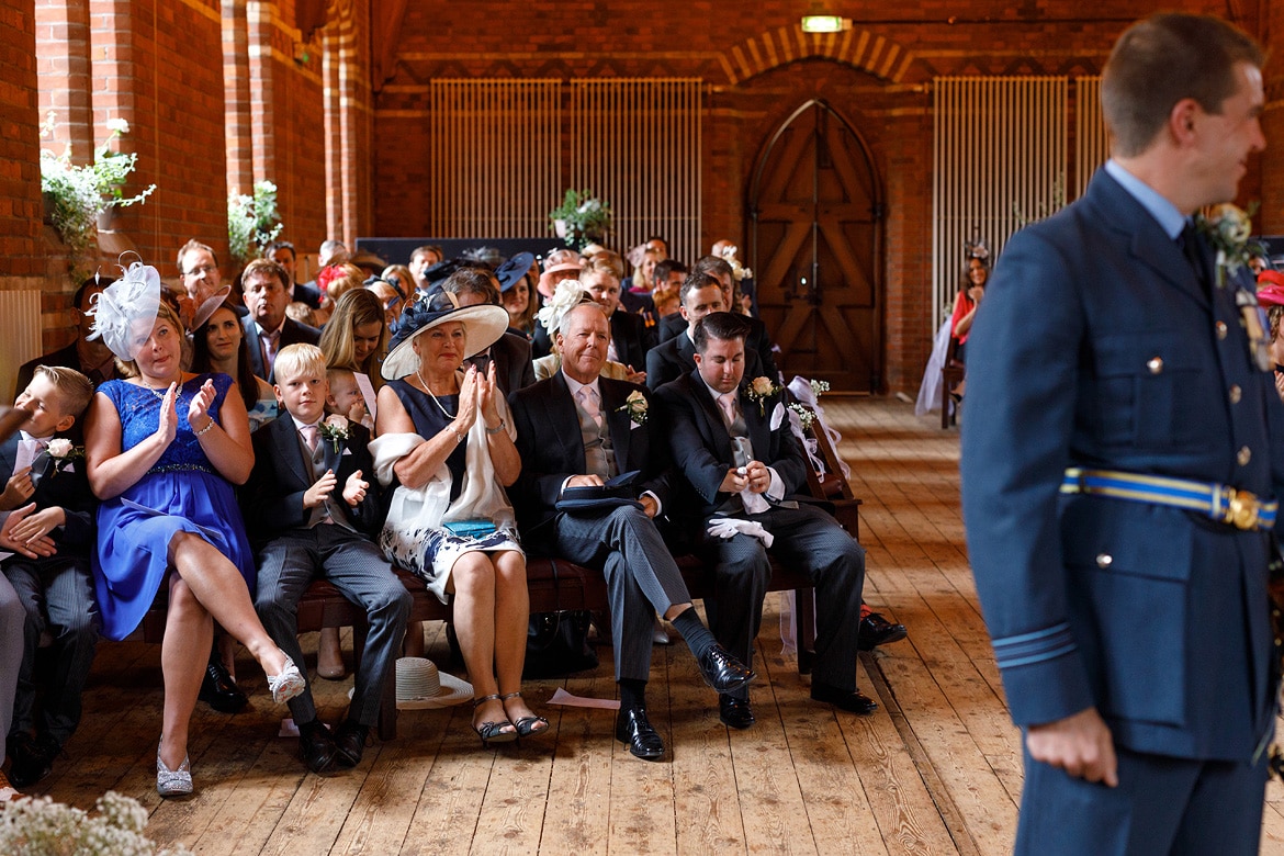 the grooms family look on during the ceremony