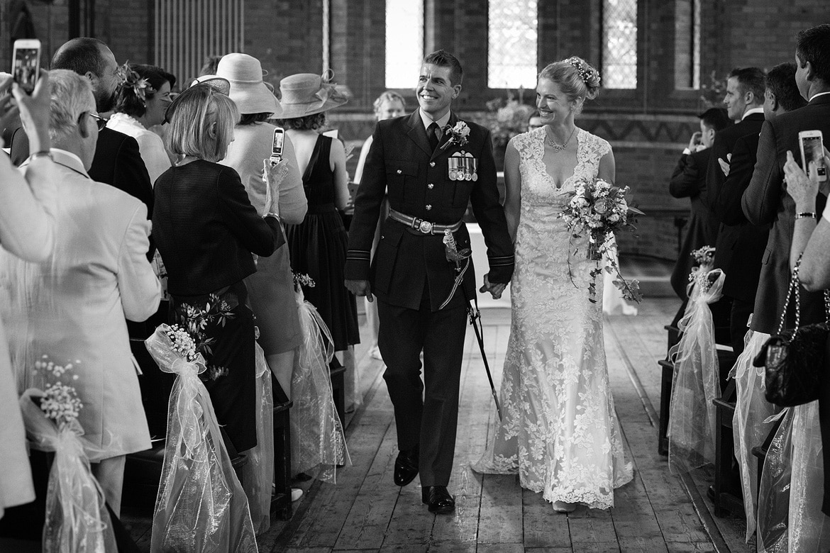 bride and groom walk down the aisle at gressenhall chapel