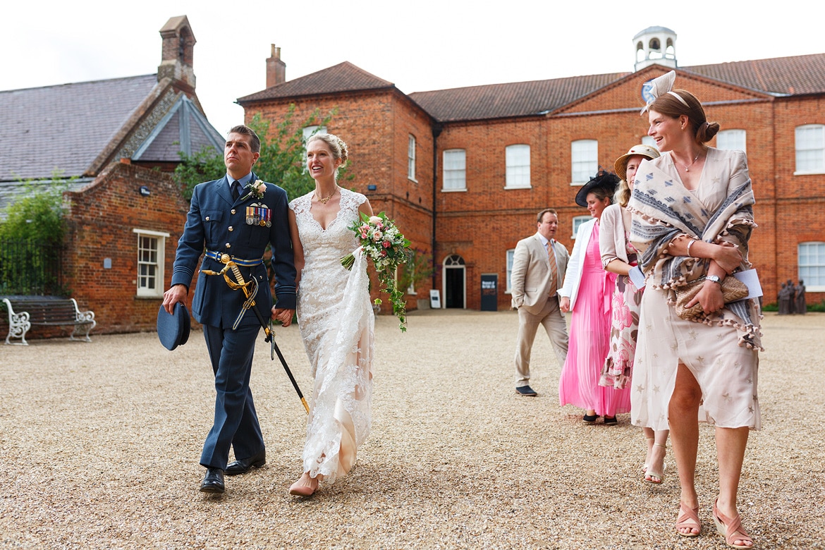 bride and groom walk to their wedding car