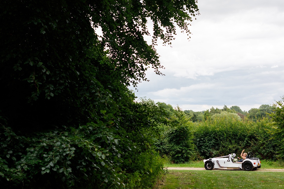 the wedding car drives through the grounds of gressenhall