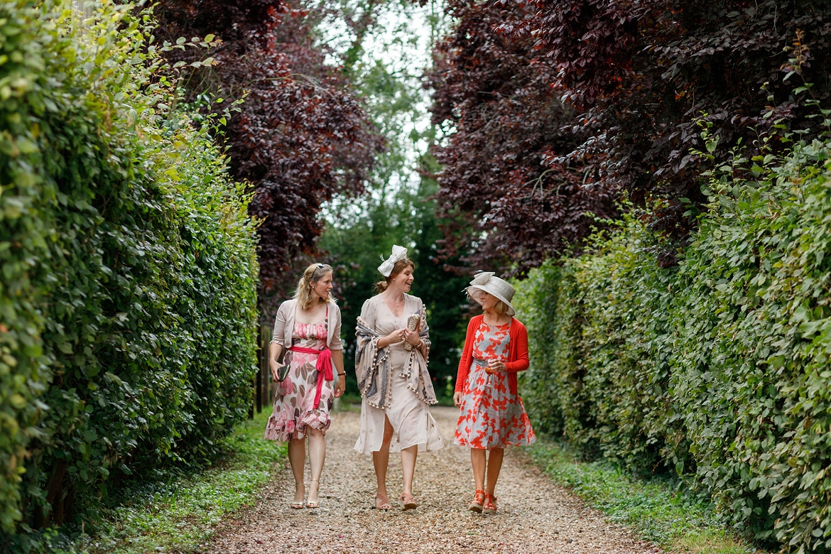 three guests walk down the drive