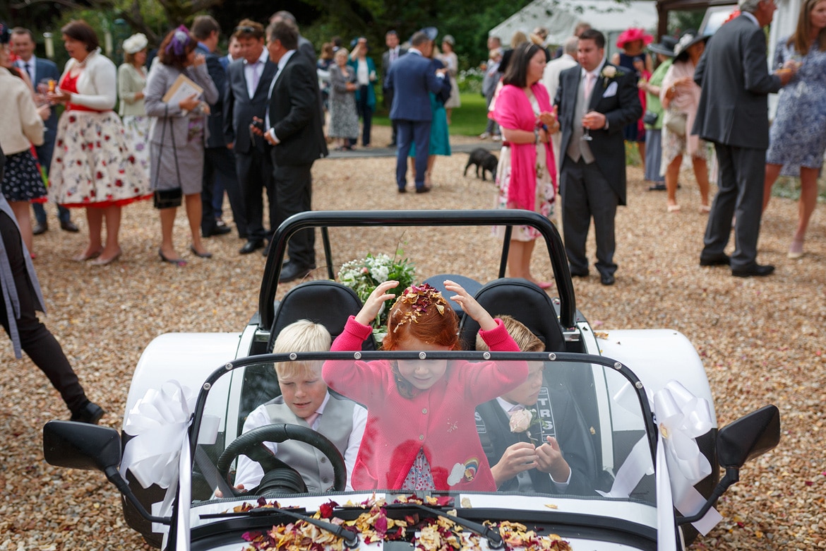 children play inside the wedding car