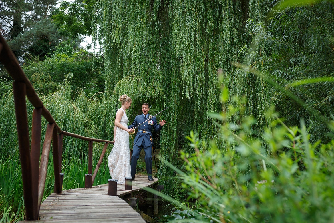 bride and groom on a bridge in the garden