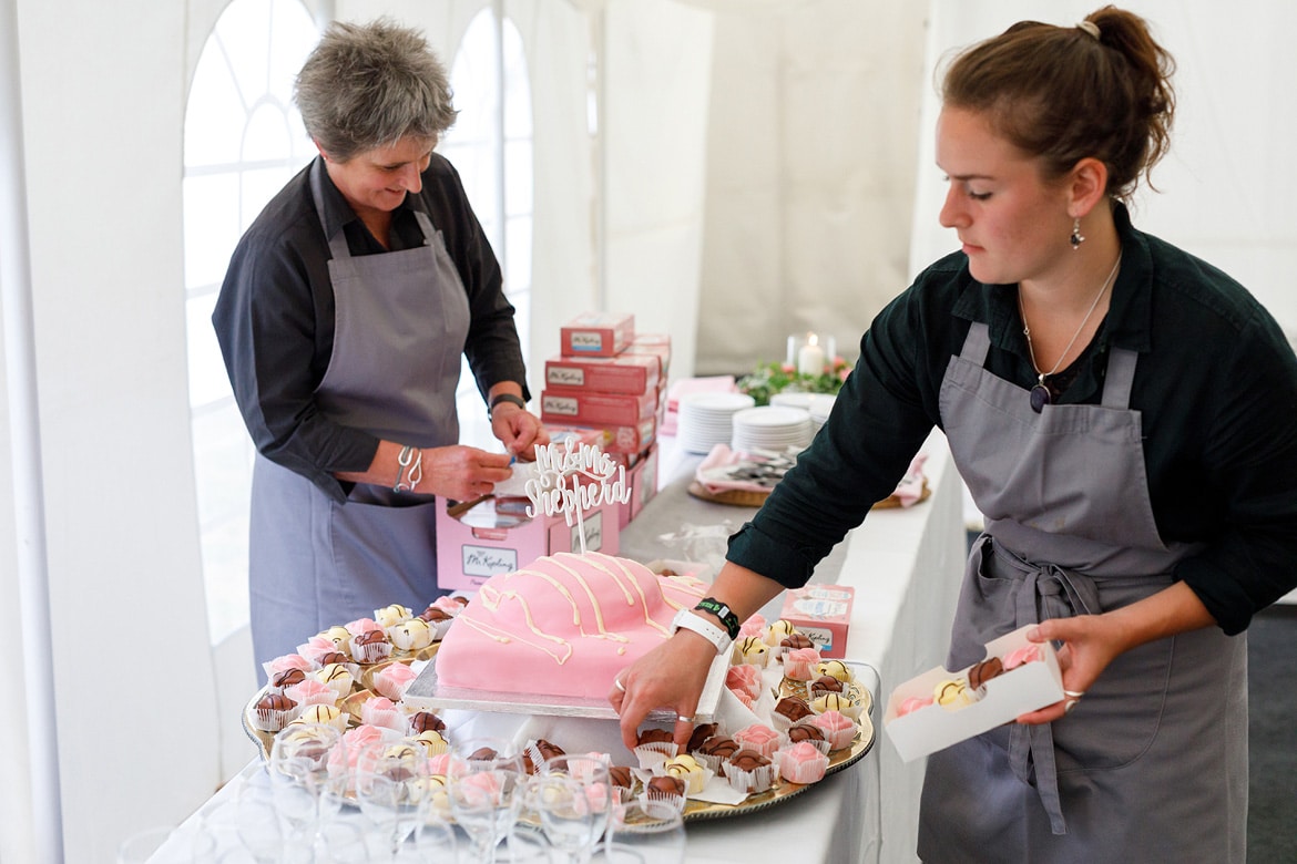 waitresses prepare the giant french fancy cake