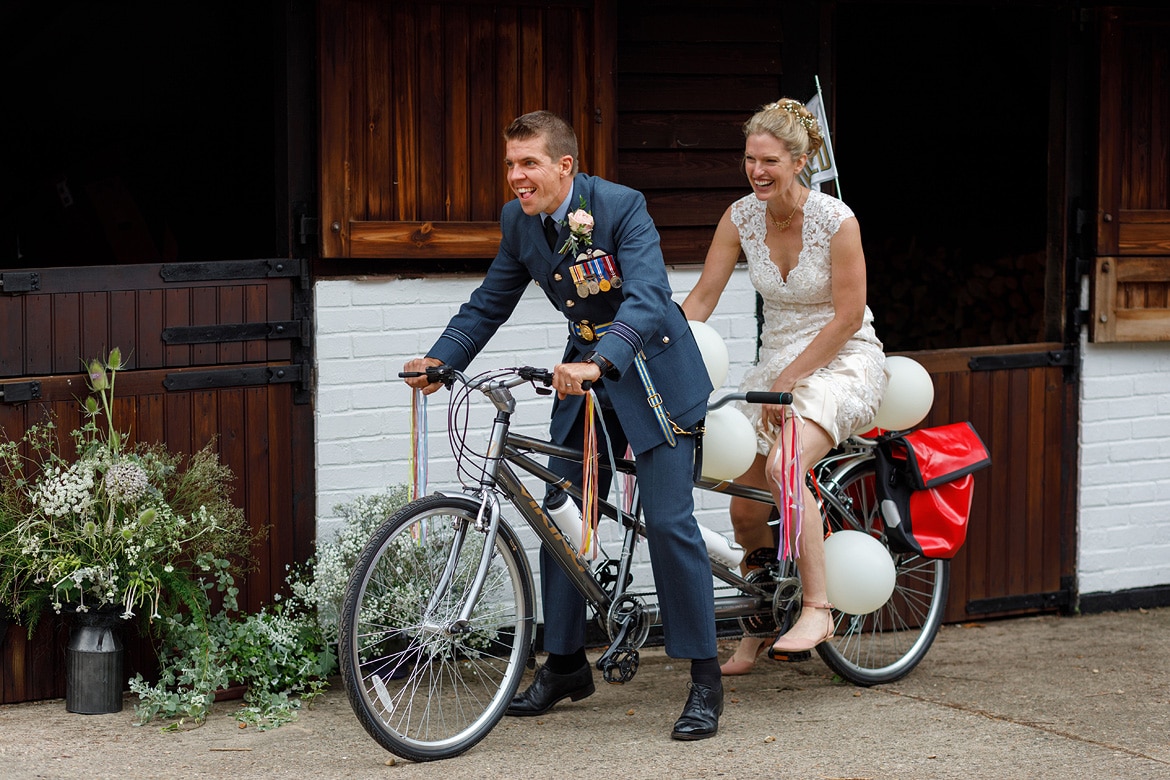 bride and groom on a tandem bicycle
