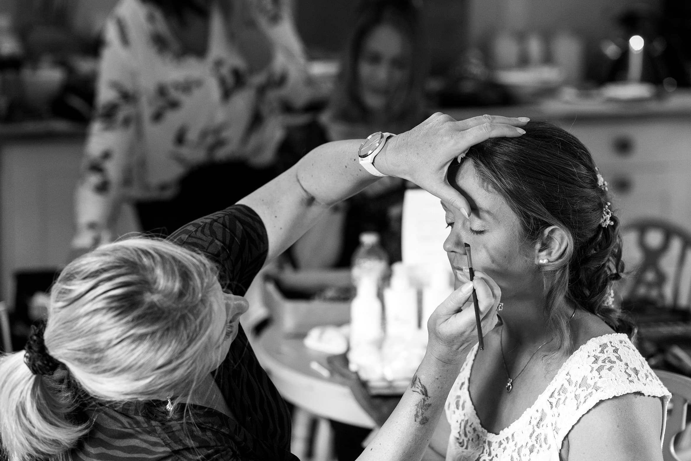 the bride has her makeup applied