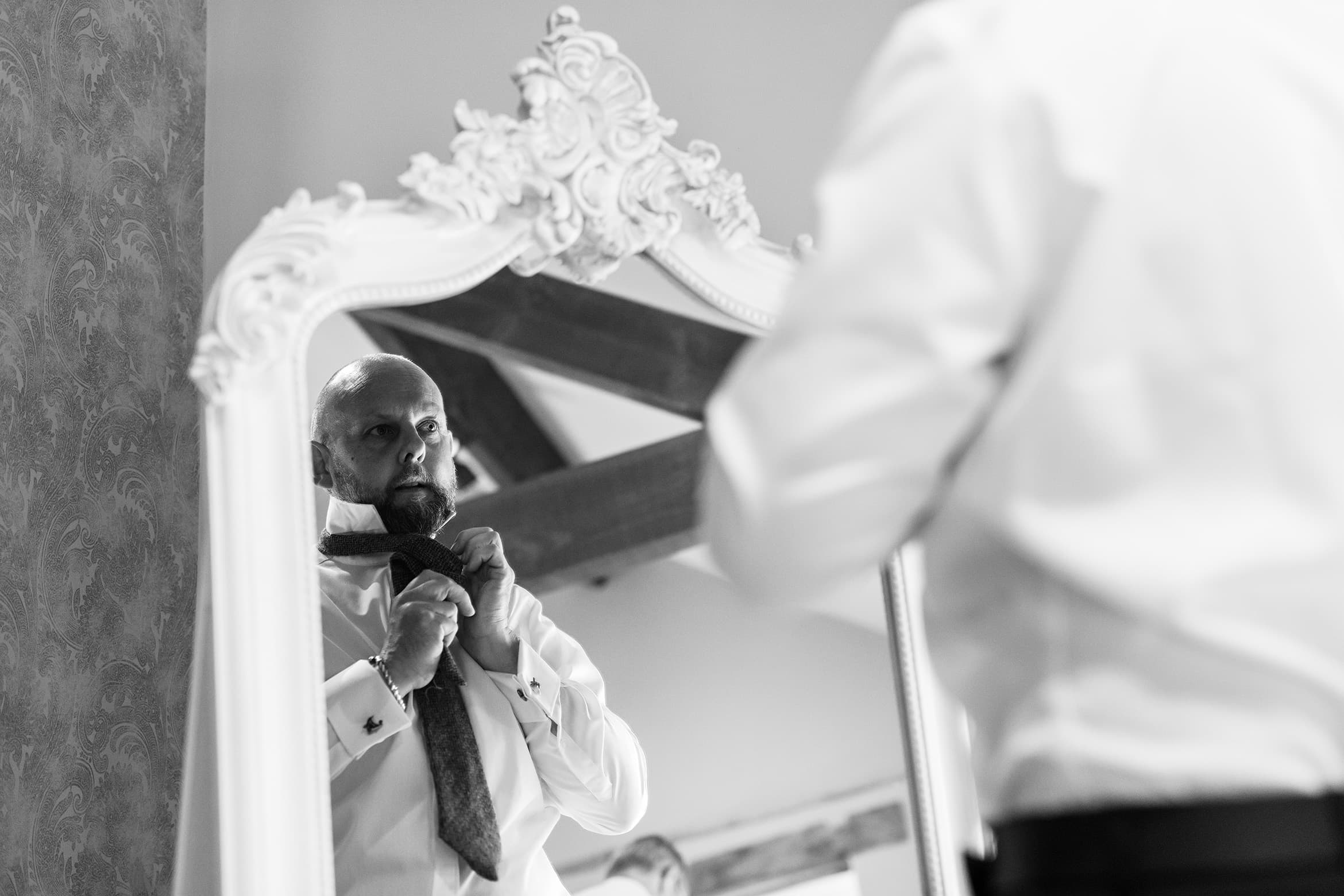 the groom gets ready for the wedding