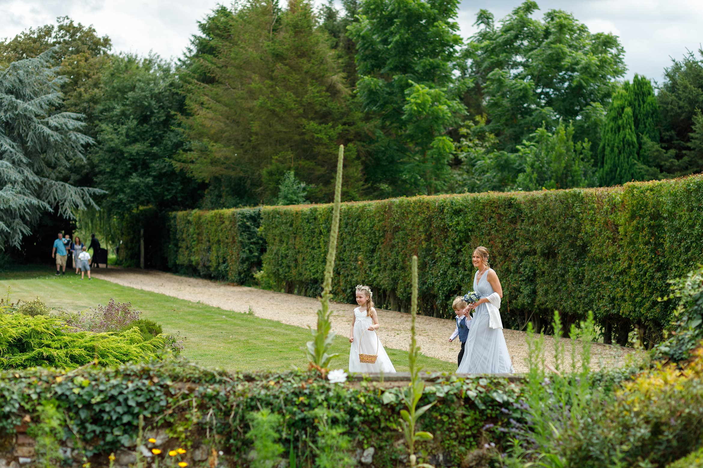 the bridesmaid and flowergirl walk across the lawn