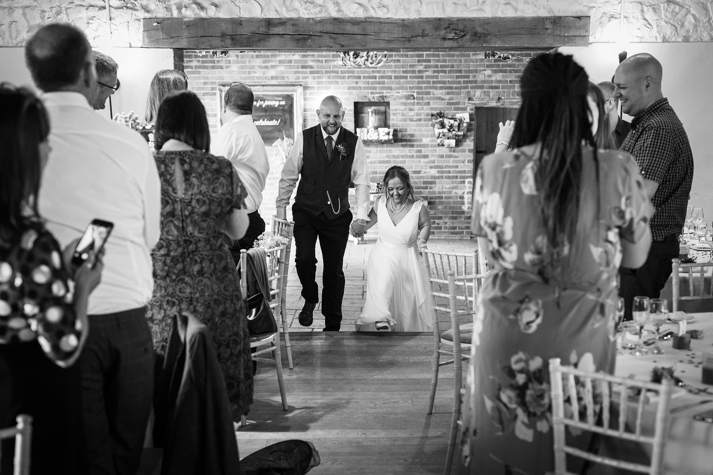 bride and groom enter the barn at hautbois hall